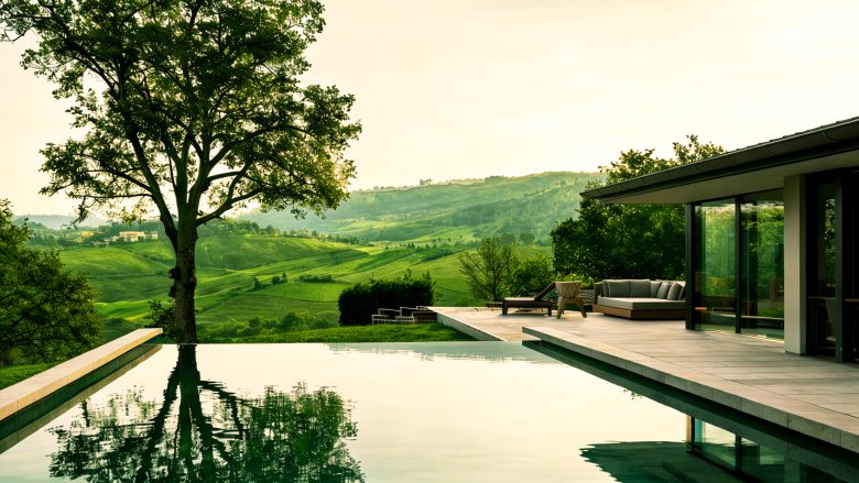 A high-angle view of a swimming pool surrounded by lush hills.